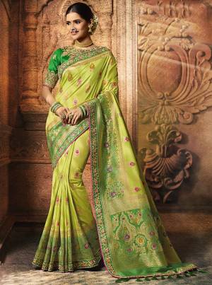 Go With The Lovely Shades Of Green In This Beautiful And Heavy Designer Saree In Light Green Color Paired With Green Colored Blouse. This Saree And Blouse Are Silk Based Beautified With Weave And Embroidery. 