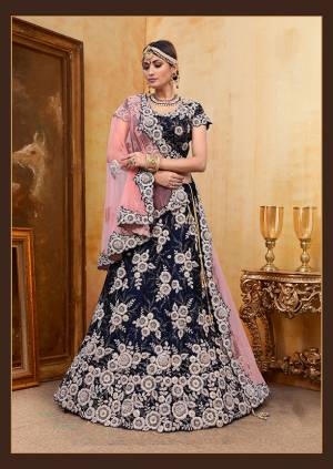 Be The Prettiest Bride Wearing This Very Beautiful And Heavy Embroidered Designer Bridal Lehenga Choli In Navy Blue Color Paired With Contrasting Baby Pink Colored Dupatta. This Lehenga Choli Is Velvet Based Paired With Net Fabricated Dupatta. Buy This Beautiful Lehenga Choli Now.