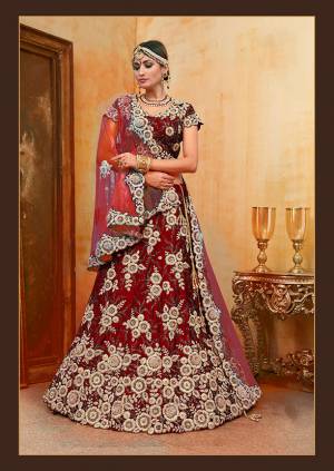Be The Prettiest Bride Wearing This Very Beautiful And Heavy Embroidered Designer Bridal Lehenga Choli In Red Color Paired With Contrasting Baby Pink Colored Dupatta. This Lehenga Choli Is Velvet Based Paired With Net Fabricated Dupatta. Buy This Beautiful Lehenga Choli Now.