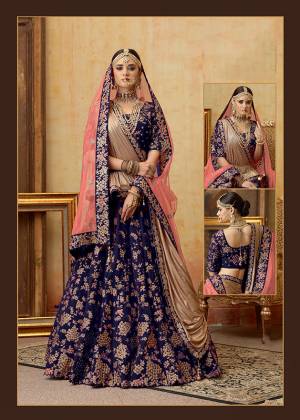 Get Ready For Your D-Day With This Heavy Designer Bridal Lehenga?Choli In Dark Blue Color Paired With Contrasting Pink Colored Dupatta. Its Heavy Embroidered Blouse And Lehenga Are Fabricated On Velvet Paired With Net Fabricated Dupatta.