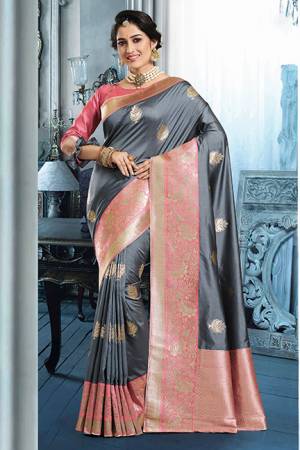 For A Bold And Beautiful Look, Grab This Silk Based Dark grey Colored Saree Paired With Pink Colored Blouse. Its Rich Art Silk Fabricated Saree Is Beautified With Detailed Weave. 