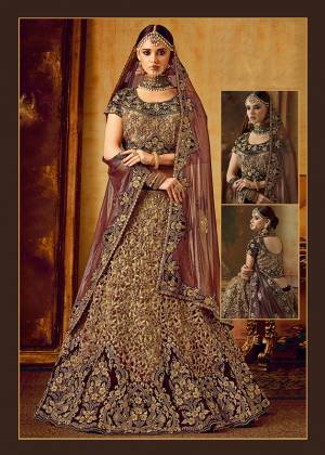 Be The Prettiest Bride Wearing This Very Beautiful And Heavy Embroidered Designer Bridal Lehenga Choli In Maroon And Dark Beige Color Paired With Maroon Colored Dupatta. This Lehenga Choli Is Velvet Based Paired With Net Fabricated Dupatta. Buy This Beautiful Lehenga Choli Now