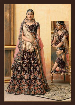 Get Ready For Your D-Day With This Heavy Designer Bridal Lehenga?Choli In Maroon Color Paired With Contrasting Peach Colored Dupatta. Its Heavy Embroidered Blouse And Lehenga Are Fabricated On Velvet Paired With Net Fabricated Dupatta