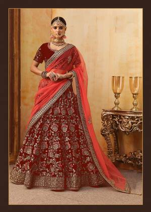 Be The Prettiest Bride Wearing This Very Beautiful And Heavy Embroidered Designer Bridal Lehenga Choli In Red Color Paired With Red Colored Dupatta. This Lehenga Choli Is Velvet Based Paired With Net Fabricated Dupatta. Buy This Beautiful Lehenga Choli Now