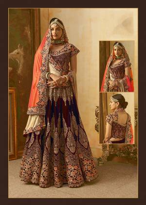 Be The Prettiest Bride Wearing This Very Beautiful And Heavy Embroidered Designer Bridal Lehenga Choli In Maroon Color Paired With Contrasting Orange Colored Dupatta. This Lehenga Choli Is Velvet Based Paired With Net Fabricated Dupatta. Buy This Beautiful Lehenga Choli Now