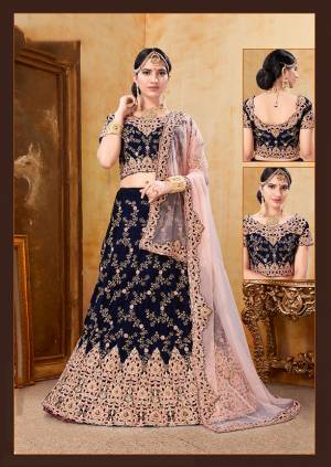 Get Ready For Your D-Day With This Heavy Designer Bridal Lehenga?Choli In Navy Blue Color Paired With Contrasting Baby Pink Colored Dupatta. Its Heavy Embroidered Blouse And Lehenga Are Fabricated On Velvet Paired With Net Fabricated Dupatta