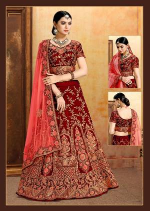 Be The Prettiest Bride Wearing This Very Beautiful And Heavy Embroidered Designer Bridal Lehenga Choli In Red Color Paired With Red Colored Dupatta. This Lehenga Choli Is Velvet Based Paired With Net Fabricated Dupatta. Buy This Beautiful Lehenga Choli Now