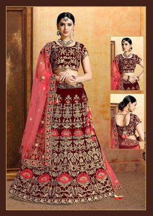 Get Ready For Your D-Day With This Heavy Designer Bridal Lehenga?Choli In Maroon Color Paired With Contrasting Crimson Red Colored Dupatta. Its Heavy Embroidered Blouse And Lehenga Are Fabricated On Velvet Paired With Net Fabricated Dupatta