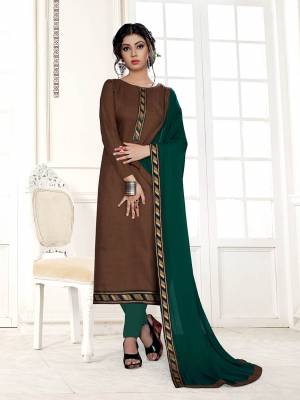 For Your Semi-Casual Wear, Grab This Pretty Dress Material In Brown Color Paired With Contrasting Pine Green Colored Bottom And Dupatta. Its Top Is Fabricated On Cotton Slub Paired With Cotton Bottom And Chiffon Fabricated Dupatta. 