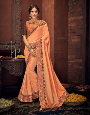 Dripping in fresh ethnic hues and imbibed with tasteful floral details, this bright peach saree will make for a stylish pick this festive season. Pair with fashion jhumkis to complete the look. 