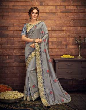 Look subtle and appealing in this basic grey saree enriched with floral print and delicate embroidered details for you next festive soiree. 