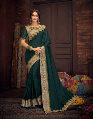 Drenched in a magnificent shade of emerald green and perked up with gorgeous gold embroidery and floral details, this saree will steal multiple appreciative glances. 