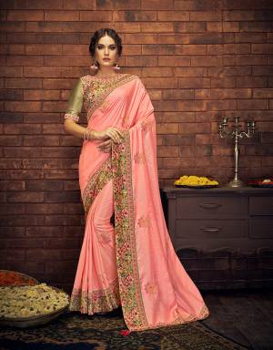 Emanate an aesthetically pleasing vibe in thi feminine and delicate peach saree with subtle embroidered buttis and digital printed floral border. Drape in a classic falling pallu style to look ethereal. 