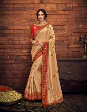 This precious Beige and red saree is a timeless piece to own. Savour it on your special day and treasure the look for years to come. 
