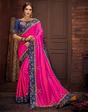 Radiate a supreme outlook in this dynamic pink saree color blocked with regal shade of blue. Pair with subtle gold jewelry to balance the look. 