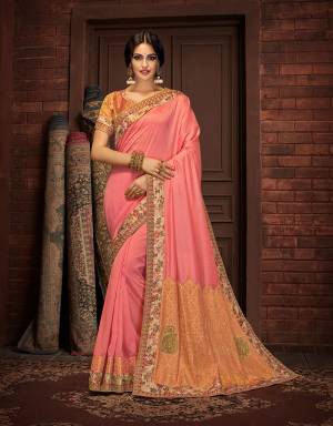 Exhibit your rich ethnic wear tastes in this elegant and graceful peach saree with a regal brocade short pallu adorned with handwork buttis. Pair with oxidized gold jewels to complete the look. 