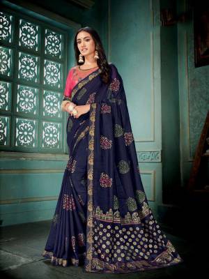 Enhance Your Personality Wearing This Pretty Designer Saree In Navy Blue Color Paired With Contrasting Pink Colored Blouse. This Silk Based Saree Gives A Rich And Elegant Look To Your Personality. 