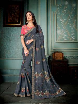 Enhance Your Personality Wearing This Pretty Designer Saree In Dark Grey Color Paired With Contrasting Pink Colored Blouse. This Silk Based Saree Gives A Rich And Elegant Look To Your Personality. 