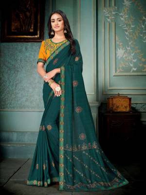 Enhance Your Personality Wearing This Pretty Designer Saree In Teal Blue Color Paired With Contrasting Musturd Yellow Colored Blouse. This Silk Based Saree Gives A Rich And Elegant Look To Your Personality. 