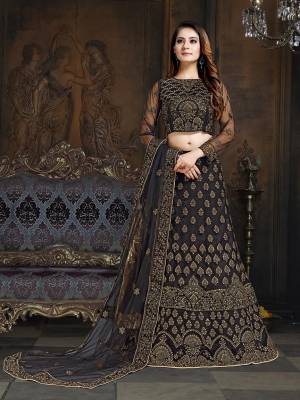 Here Is A Very Designer Lehenga Choli To Add Into Your Wardrobe For The Upcoming Wedding Season In Black. Its Pretty Blouse And Lehenga Are Fabricated On Net With Satin Inner Paired With Net Fabricated Dupatta. Its Bold Color And Heavy Embroidery Will Definitely Earn You Lots Of Compliments From Onlookers. 