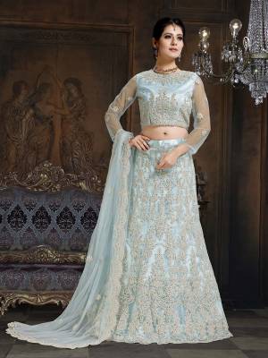 Here Is A Very Designer Lehenga Choli To Add Into Your Wardrobe For The Upcoming Wedding Season In Baby Blue. Its Pretty Blouse And Lehenga Are Fabricated On Net With Satin Inner Paired With Net Fabricated Dupatta. Its Pretty Color And Heavy Embroidery Will Definitely Earn You Lots Of Compliments From Onlookers. 