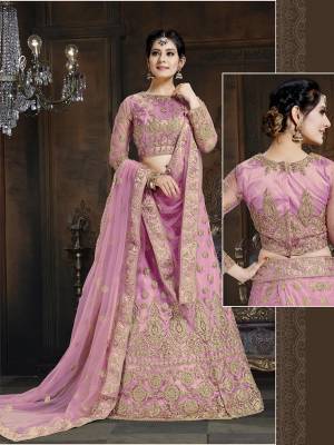 Here Is A Very Designer Lehenga Choli To Add Into Your Wardrobe For The Upcoming Wedding Season In Pink. Its Pretty Blouse And Lehenga Are Fabricated On Net With Satin Inner Paired With Net Fabricated Dupatta. Its Pretty Color And Heavy Embroidery Will Definitely Earn You Lots Of Compliments From Onlookers. 