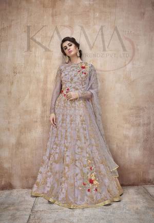 Flaunt Your Rich And Rich And Elegant Taste Wearing This Designer Heavy Floor Length Suit In All Over Grey. Its Heavy Embroidered Top Is Fabricated On Net Paired With Satin Silk Bottom And Net Fabricated Dupatta. Its Attractive Embroidery, Subtle Color And Designer Look Will Earn You Lots Of Compliments From Onlookers. 