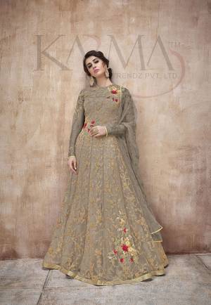 Flaunt Your Rich And Rich And Elegant Taste Wearing This Designer Heavy Floor Length Suit In All Over Dark Grey. Its Heavy Embroidered Top Is Fabricated On Net Paired With Satin Silk Bottom And Net Fabricated Dupatta. Its Attractive Embroidery, Subtle Color And Designer Look Will Earn You Lots Of Compliments From Onlookers. 