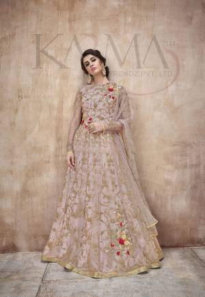Flaunt Your Rich And Rich And Elegant Taste Wearing This Designer Heavy Floor Length Suit In All Over Pastel Pink. Its Heavy Embroidered Top Is Fabricated On Net Paired With Satin Silk Bottom And Net Fabricated Dupatta. Its Attractive Embroidery, Subtle Color And Designer Look Will Earn You Lots Of Compliments From Onlookers. 