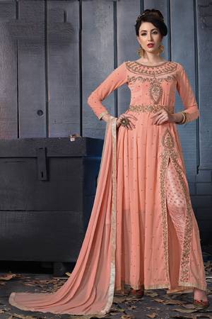 A Must Have Shade In Every Womens Wardrobe Is Here With This Designer Suit In Peach Color. Its Heavy Embroidered Top Is Fabricated On Georgette Paired With Jacquard Silk Bottom And Chiffon Fabricated Dupatta. Its Lovely Front Slit Pattern Will Give An Enhanced Look To Your Personality. 