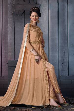 A Must Have Shade In Every Womens Wardrobe Is Here With This Designer Suit In Beige Color. Its Heavy Embroidered Top Is Fabricated On Georgette Paired With Jacquard Silk Bottom And Chiffon Fabricated Dupatta. Its Lovely Front Slit Pattern Will Give An Enhanced Look To Your Personality. 
