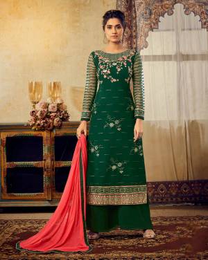 Celebrate This Festive Season With Beauty And Comfort Wearing This Designer Straight Suit In Dark Green Color Paired With Contrasting Crimson Red Colored Dupatta. Its Pretty Embroidered Georgette Based Top Is Paired With Santoon Bottom And Chiffon Fabricated Dupatta. 