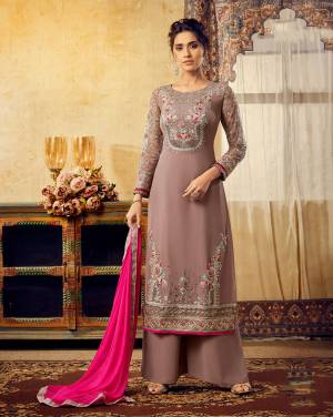 New And Unique Shade Is Here To Add Into Your Wardrobe With This Heavy Designer Straight Suit In Mauve Color Paired With Contrasting Dark Pink Colored Dupatta. Its Top IS Georgette Based Paired With Santoon Bottom And Chiffon Fabricated Dupatta. 