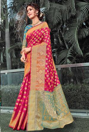 This Festive Adorn A Proper Traditional Look Wearing This Silk Based Saree In Dark Pink Color Paired With Contrasting Blue Colored Blouse. This Saree And Blouse are Fabricated On Art Silk Beautified With Weave All Over. 