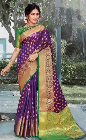 You Will Deinitely Earn Lots Of Compliments In This Beautiful Traditional Look With Silk Based Saree In Purple Color Paired With Contrasting Green Colored Blouse. This Saree And Blouse Are Fabricated On Art Silk Beautified With Weave All Over. 