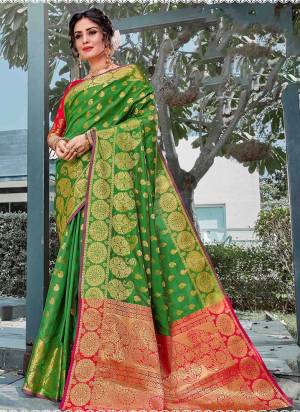 You Will Deinitely Earn Lots Of Compliments In This Beautiful Traditional Look With Silk Based Saree In Green Color Paired With Contrasting Dark Pink Colored Blouse. This Saree And Blouse Are Fabricated On Art Silk Beautified With Weave All Over. 