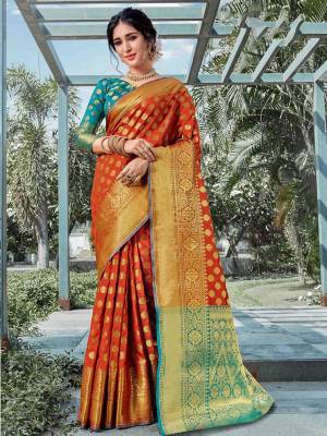 You Will Deinitely Earn Lots Of Compliments In This Beautiful Traditional Look With Silk Based Saree In Rust Orange Color Paired With Contrasting Blue Colored Blouse. This Saree And Blouse Are Fabricated On Art Silk Beautified With Weave All Over. 