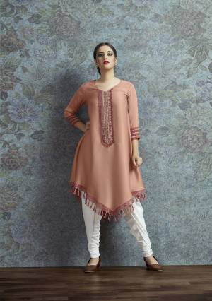Celebrate This Festive Season With A New Indo-Western Look Wearing This Pair Of Kurti In Peach Color Paired With White Colored Bottom. Its Top Is Fabricated On Modal Satin Beautified With Embroidered Lace Border Paired With Crepe Fabricated Unstitched Bottom. Buy This Lovely Pair Now.