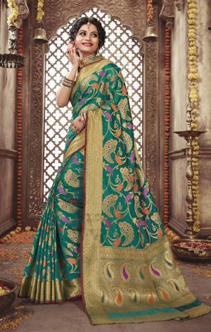 Add This Very Beautiful Heavy Weaved Designer Saree To Your Wardrobe In Sea Green Color Paired With Sea Green And Gold Colored Blouse. This Saree And Blouse Are Silk Based Beautified With Weave. It Is Pretty Suitable For The Upcoming Festive And Wedding Season. 