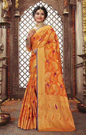 Look Attractive In This Silk Based Orange Colored Saree Paired With Orange And Golden Blouse. It Has Very Attractive Weave All Over Giving An Enhanced Look To The Saree. 