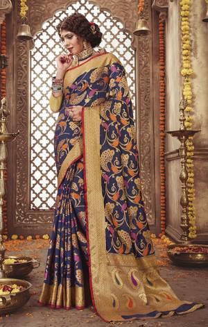 Add This Very Beautiful Heavy Weaved Designer Saree To Your Wardrobe In Navy Blue Color Paired With Navy Blue And Gold Colored Blouse. This Saree And Blouse Are Silk Based Beautified With Weave. It Is Pretty Suitable For The Upcoming Festive And Wedding Season. 