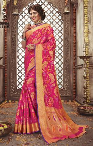 Look Attractive In This Silk Based Rani Pink Colored Saree Paired With Rani Pink And Golden Blouse. It Has Very Attractive Weave All Over Giving An Enhanced Look To The Saree. 