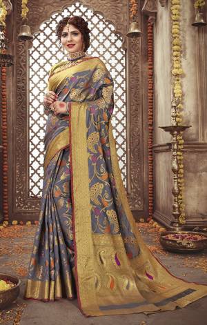 Add This Very Beautiful Heavy Weaved Designer Saree To Your Wardrobe In Grey Color Paired With Grey And Gold Colored Blouse. This Saree And Blouse Are Silk Based Beautified With Weave. It Is Pretty Suitable For The Upcoming Festive And Wedding Season. 