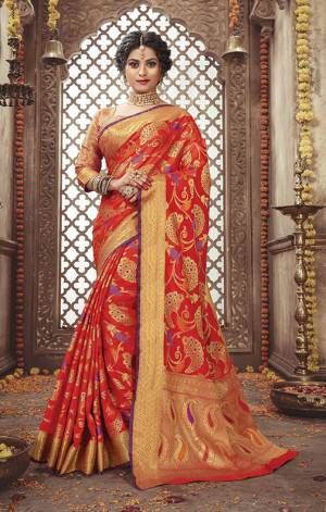 Look Attractive In This Silk Based Red Colored Saree Paired With Red And Golden Blouse. It Has Very Attractive Weave All Over Giving An Enhanced Look To The Saree. 
