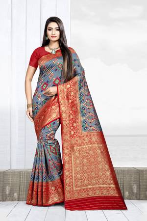 Grab This Rich Saree In Dark Grey Color Paired With Contrasting Red Colored Blouse. This Saree Is Fabricated On Weaving Silk Paired With Art Silk Fabricated Blouse. 