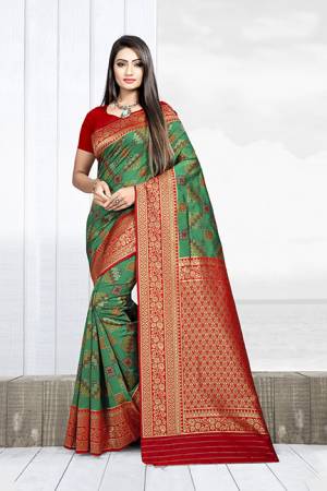 Celebrate This Festive Season With Beauty And Comfort Wearing This Designer Silk Based Saree In Green Color Paired With Red Colored Blouse. This Saree Is Weaving Silk Based Paired With Art Silk Fabricated Blouse. It Will Give A Proper Traditional Look To Your Personality. 