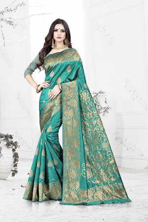 Enhance Your Personality Wearing This Rich Silk Based Designer Saree In Turquoise Blue Color Paired With Navy Blue Colored Blouse. This Saree Is Beautified With Bold Weave Giving It An Enhanced Look.