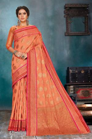 Celebrate This Festive Season In A Very Elegant Look With This Silk Based Orange Colored Saree. This Saree IS Fabricated On Handloom Cotton Silk Paired With Jacquard Silk Fabricated Blouse. 