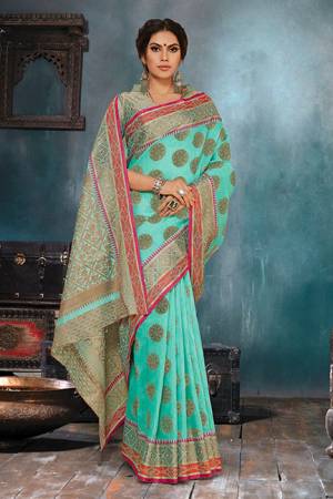 Flaunt Your Rich And Elegant Taste In This Elegant Looking Turquoise Blue Colored Saree. This Saree Is Fabricated On Handloom Cotton Silk Paired With Jacquard Silk Fabricated Blouse. It Is Beautified With Weave Giving An Enhanced Look.