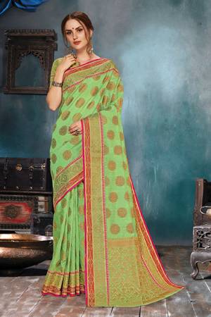 Flaunt Your Rich And Elegant Taste In This Elegant Looking Light Green Colored Saree. This Saree Is Fabricated On Handloom Cotton Silk Paired With Jacquard Silk Fabricated Blouse. It Is Beautified With Weave Giving An Enhanced Look.